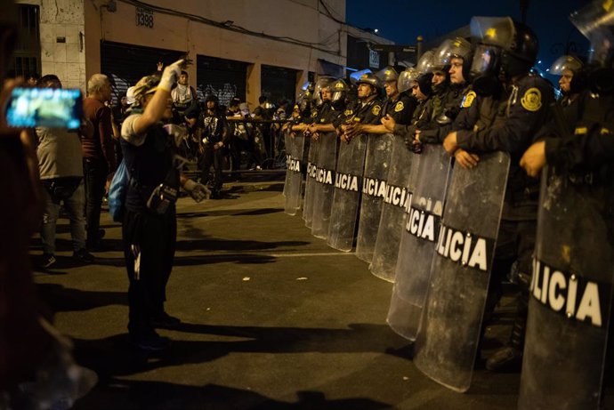 31 January 2023, Peru, Lima: A demonstrator confronts police during a protest against the government of Peruvian President Dina Boluarte. Photo: Hector Adolfo Quintanar Perez/ZUMA Press Wire/dpa