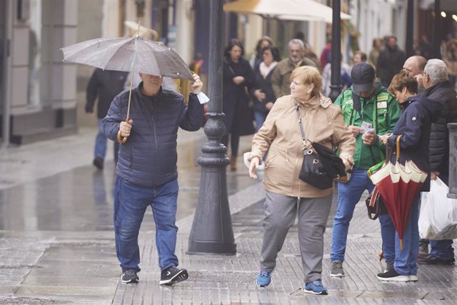 Archivo - Un hombre aguanta su paraguas para que el viento no lo vuele durante la llegada de la borrasca Efraín a Cádiz, a 13 de diciembre de 2022 en Cádiz (Andalucía, España). (Foto de archivo).