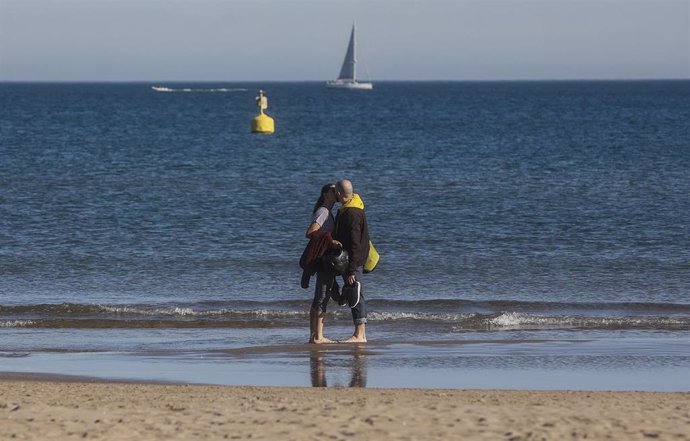 Archivo - Una pareja ese besa en la orilla de la playa