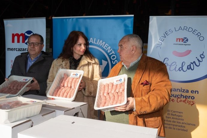 El presidente del Banco de Alimentos, José Ignacio Alfaro; y la concejal delegada de Mercados, Carmen Herrarte, en la entrega de 580 raciones de longaniza en Mercazagoza para celebrar el Jueves Lardero