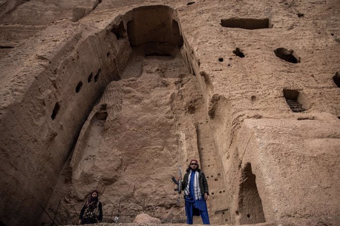 Archivo - 15 November 2022, Afghanistan, Bamyan: Two Taliban fighters patrol at the site where a monumental, 38 meters tall Buddha statue was carved into the side of a cliff in Bamyan. Two massive buddha statues with the smaller reaching 38 and the larg