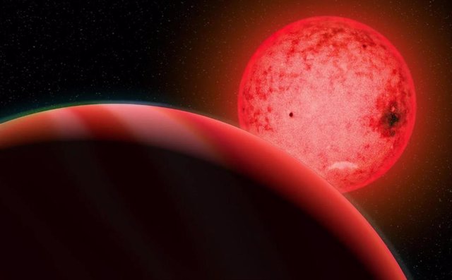 Concepción artística de un gran planeta gigante gaseoso en órbita alrededor de una pequeña estrella enana roja llamada TOI-5205.