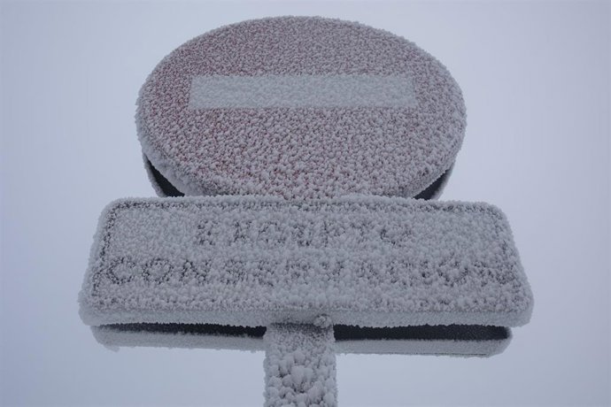 Archivo - Una señal de tráfico congelada en el Puerto de Navacerrada