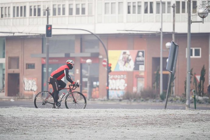 Un ciclista circula por una calle cubierta de nieve, a 9 de febrero de 2023, en Vitoria-Gasteiz