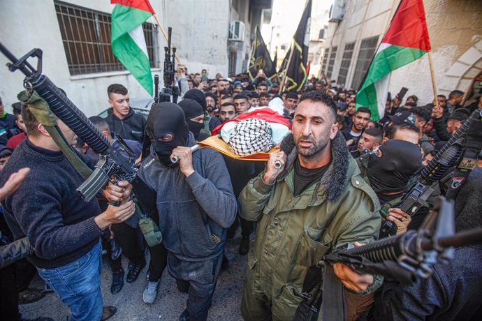 February 14, 2023, Jenin, West bank, Palestine: (EDITOR'S NOTE: Image depicts death).Palestinian gunmen carry the body of the Palestinian Mahmoud al-Aidi, 17-years old, who was killed by Israeli army bullets during a raid on the al-FaraAa refugee camp ne
