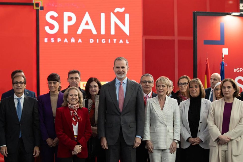 El presidente de Fira de Barcelona, Pau Relat (1i); la vicepresidenta primera del Gobierno y ministra de Asuntos Económicos y Transformación Digital, Nadia Calviño (3i); y el Rey Felipe VI (c); durante el recorrido protocolario por el MWC