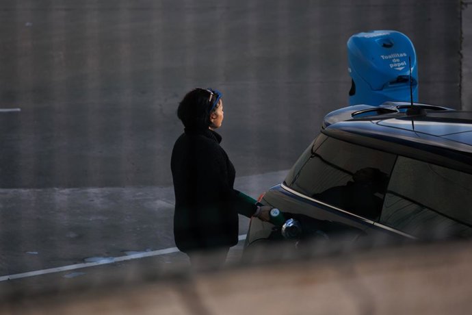 Archivo - Una mujer reposta combustible en una gasolinera, a 2 de diciembre de 2022, en Madrid (España).