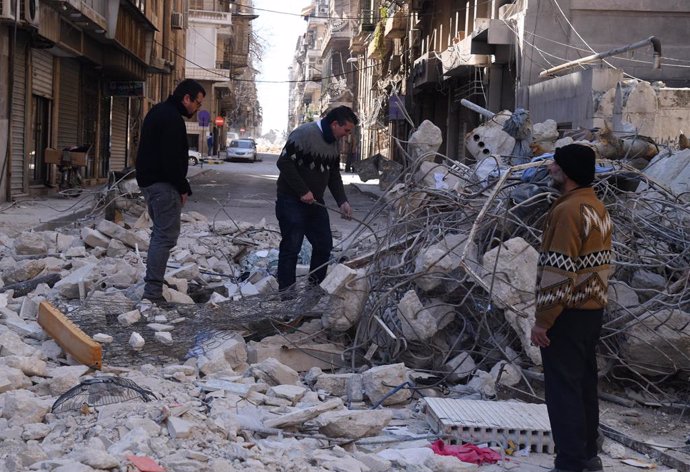 ALEPPO (SYRIA), Feb. 17, 2023  -- Displaced people check on belongings among the rubble of a shattered building in Aleppo, Syria, on Feb. 17, 2023.,Image: 756861255, License: Rights-managed, Restrictions: , Model Release: no, Credit line: Stringer / Xin