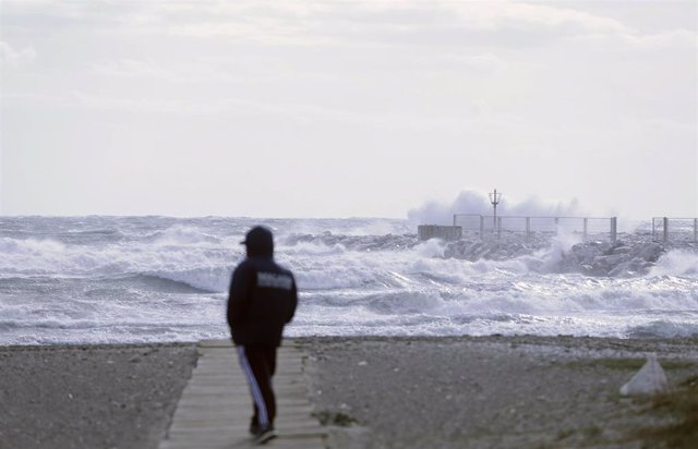 Varias personas en la playa de la Malagueta donde el temporal con vientos de 70 km/h y el litoral malagueño registra olas de tres metros, a 10 de febrero de 2023 en Málaga (Andalucía, España). (Foto de archivo).