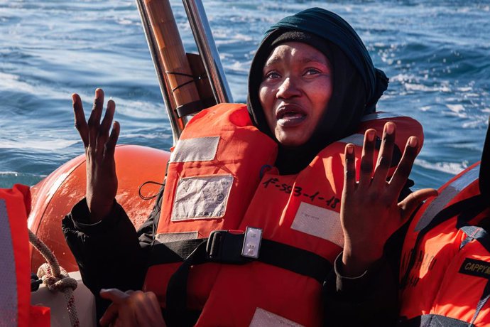 21 February 2023, Italy, Lampedusa: Amigrant cheers on the stern of the humanitarian ship Aita Mari after it completed the rescue of 40 African migrants 44.5 miles off Lampedusa. 40 sub-Saharan migrants boarding a precarious metal boat were rescued 44 