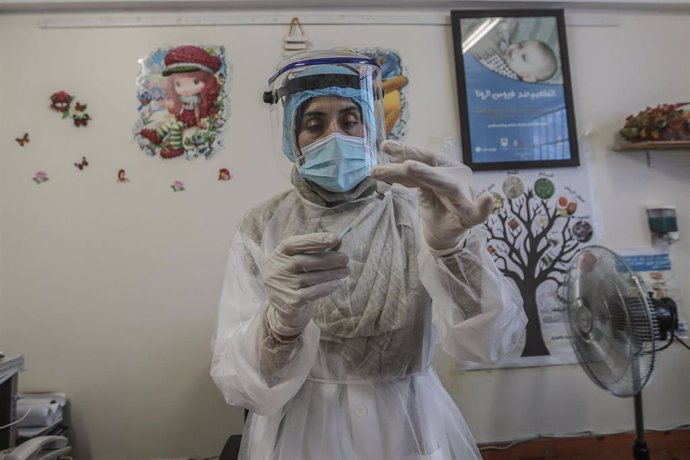 Archivo - Una trabajadora sanitaria prepara vacunas contra la polio para niños en una clínica en el campamento de Shati. A 13 de septiembre de 2020, en los territorios palestinos de Gaza.