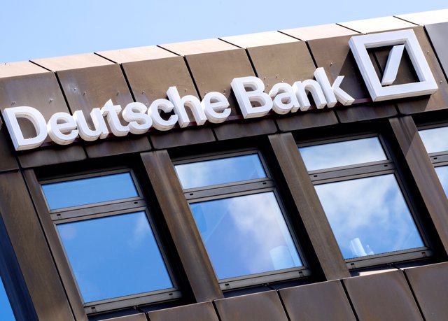 FILED - 24 April 2021, Lower Saxony, Oldenburg: The Deutsche Bank logo and lettering hang on a branch in the city center. Photo: Hauke-Christian Dittrich/dpa