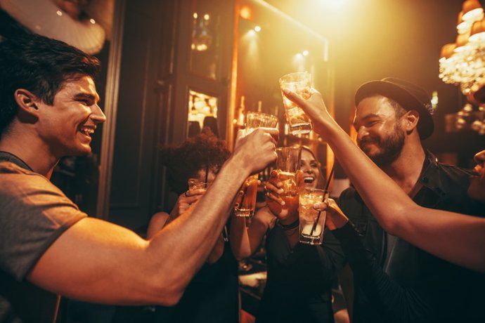 Archivo - Amigos  bebiendo alcohol en un bar.