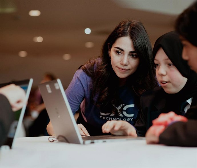 Students learning coding with DXC expert (Credit: Manchester United Foundation)