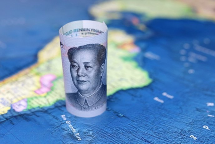 March 29, 2023: Chinese yuan on the map of South America. Trading between China and Latin American countries, economy and investment