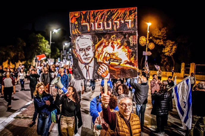 Archivo - March 1, 2023, Jerusalem, Israel: Protestors hold banner depicting the Israeli Prime Minister Benjamin Netanyahu and reads: ''Dictator'' during a demonstration in Jerusalem. Israeli police fired stun grenades and scuffles broke out in Tel Aviv