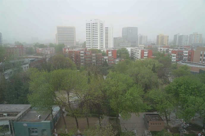 BEIJING, April 11, 2023  -- This photo taken on April 11, 2023 shows buildings shrouded in dust in Haidian District of Beijing, capital of China. Floating sand and dust affected Beijing on Tuesday.
