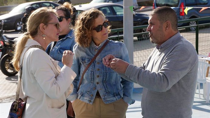 Gloria Rojas, en el centro de la imagen, en una visita al Barrio del Tiro Nacional de Melilla conversando con un vecino