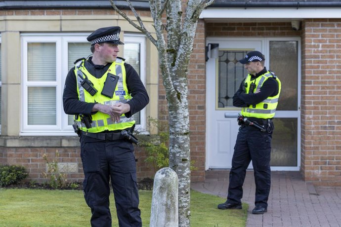 06 April 2023, United Kingdom, Glasgow: Police officers stand outside the home of former chief executive of the Scottish National Party (SNP) Peter Murrell, in Uddingston, Glasgow, after he was "released without charge pending further investigation" aft