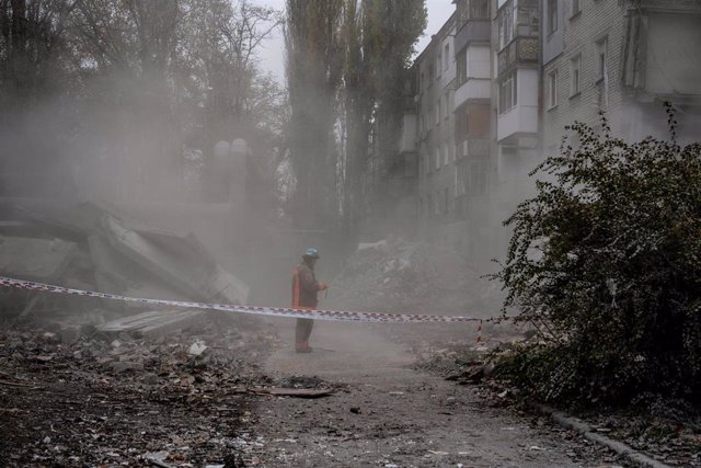 File - A rescue agent in front of a damaged residential building after a Russian missile attack on a residential building in Nikolaev, Ukraine