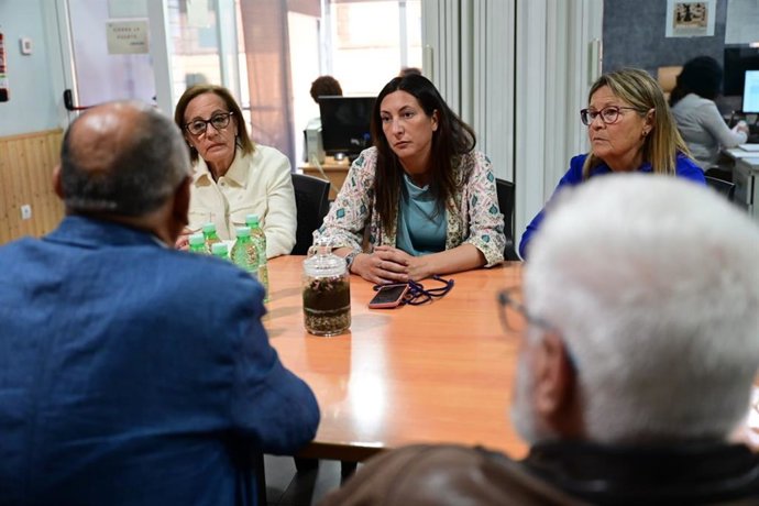 Loles López, en el centro en la imagen, visita la asociación 'Calor y café'