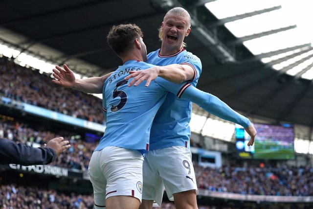 15 April 2023, United Kingdom, Manchester: Manchester City's John Stones (L) celebrates scoring their side's first goal of the game with team-mate Erling Haaland during the English Premier League soccer match between Manchester City and Leicester City at 