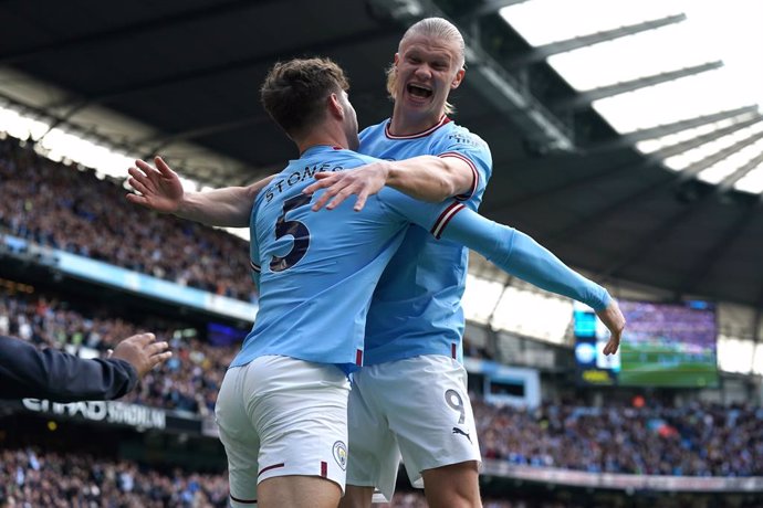 15 April 2023, United Kingdom, Manchester: Manchester City's John Stones (L) celebrates scoring their side's first goal of the game with team-mate Erling Haaland during the English Premier League soccer match between Manchester City and Leicester City a