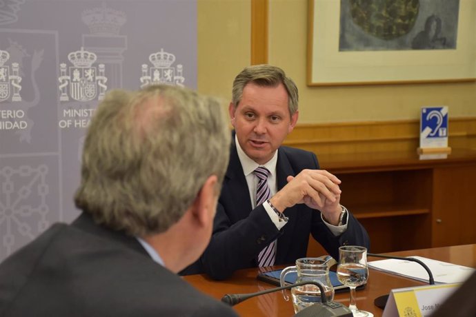 De espaldas, el presidente del Consejo General de Colegios Oficiales de Farmacéuticos (CGCOF), Jesús Aguilar, en una reunión con el ministro de Sanidad, José Miñones. En Madrid (España), a 24 de abril de 2023.