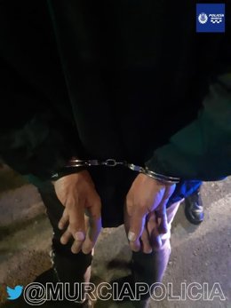 El detenido, esposado