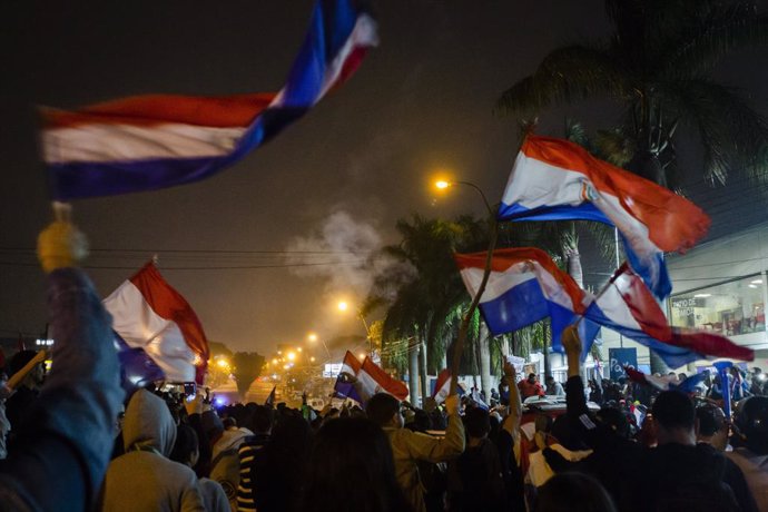May 2, 2023, Asuncion, Paraguay: People wave Paraguayan national flag as they demonstrate against the alleged electoral fraud in the recent general elections held on April 30, in the vicinity of the Superior Court of Electoral Justice (TSJE), in Asuncio