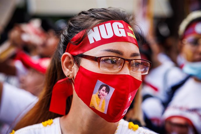 May 1, 2023, Bangkok, Thailand: A woman wears a National Unity Government of Myanmar (NUG) headband and a mask with Aung San Suu Kyi on it during a Labor Day march organized by migrant workers from Myanmar in Bangkok, Thailand, Monday, May 01, 2023.