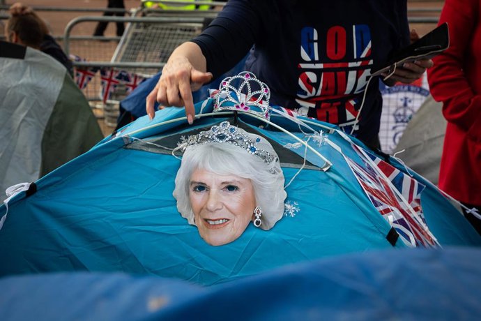 May 5, 2023, Paris, France: A mask of Queen Camilla is hung up on a tent by a royal fan, expecting to see the royal procession for the coronation of King Charles III nearby Buckingham Palace in London.