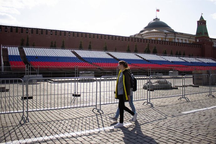 April 24, 2023, Moscow, Russia: People walk past stands coloured in the Russian flag set at Red Square. Russia celebrates Victory Day every year on May 9. Mass media reports that in 2023, only one foreign head of state will attend the traditional milita