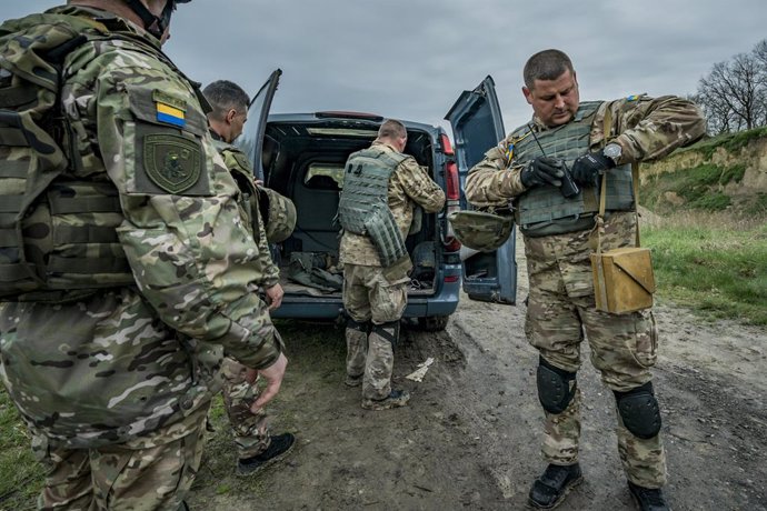 April 13, 2023, Kyiv, Kyiv, Ukraine: Members of the explosives service of the Kyiv region prepare the equipment for a controlled destruction of munitions discovered in the de-occupied territory around Kyiv, Ukraine.