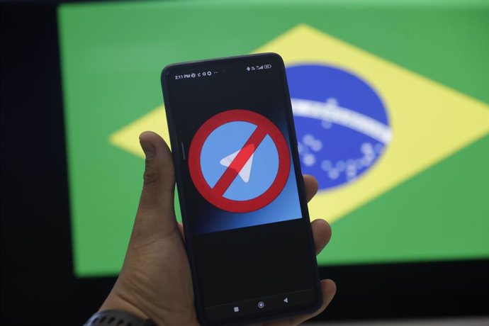 April 27, 2023, LIMA, PERU: lima 27 de abril del 2022.Producción con una bandera brasilena como fondo y delante un celular con Telegram para graficar la prohibición de esa aplicación en Brasil, con el fin de evitar los mensajes para fomentar el odio.