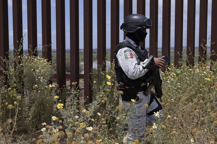 May 10, 2023, Tijuana, Baja California, Mexico: Migrants continue stuck between the Tijuana-San Diego border as some have resorted to calling delivery food and drink services on their phones to eat, while also receiving donations from good samaritans, a
