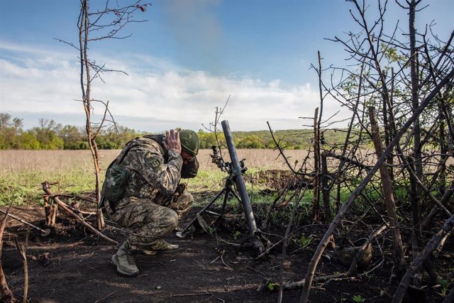 May 7, 2023, Bakhmut, Donetsk region, Ukraine: A soldier covers his ears as the mortar unit of the Armed Forces of Ukraine fires at enemy positions in the suburbs of Bakhmut, Donetsk region. The intensity of battles in the Bakhmut sector has been compared