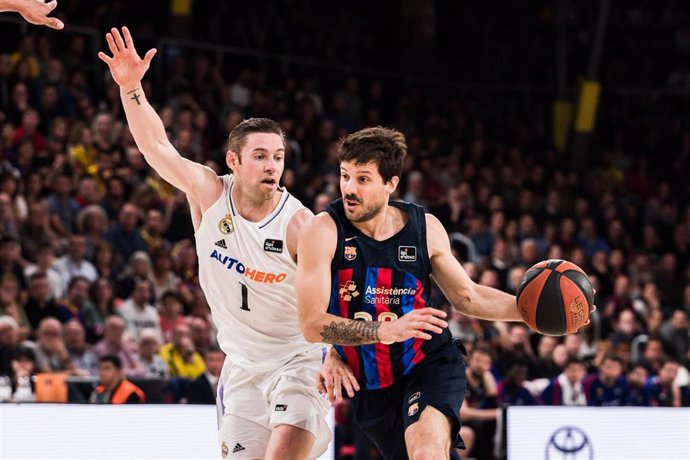 Nico Laprovittola of FC Barcelona in action against Fabien Causeur of Real Madrid during the ACB Liga Endesa match between FC Barcelona and Real Madrid at Palau Blaugrana on April 16, 2023 in Barcelona, Spain.