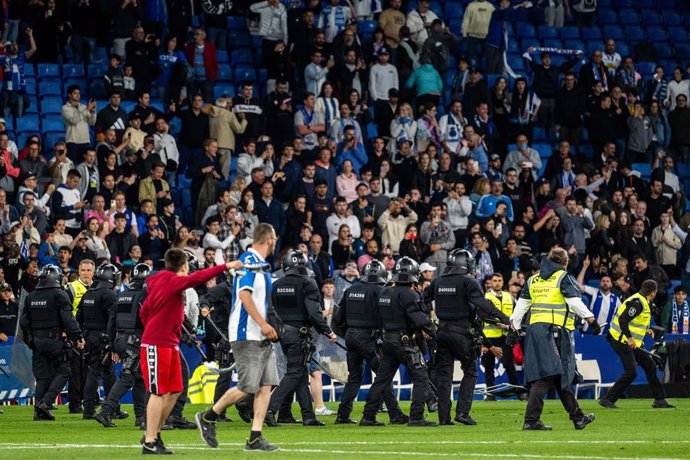 Espanyol fans invade the field and are evicted by the Mossos de Esquadra during the spanish league, La Liga Santander, football match played between RCD Espanyol and FC Barcelona  at RCD Stadium on May 14, 2023, in Barcelona, Spain.