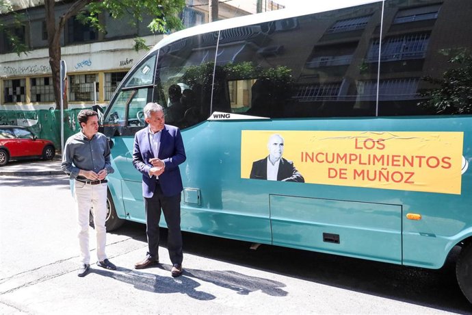 El candidato a la Alcaldía de Sevilla por el PP, José Luis Sanz, junto al "autobús de los incumplimientos de Muñoz".
