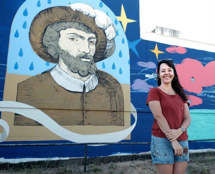 La artista Ana Langeheldt, junto al mural de la barriada Elcano.