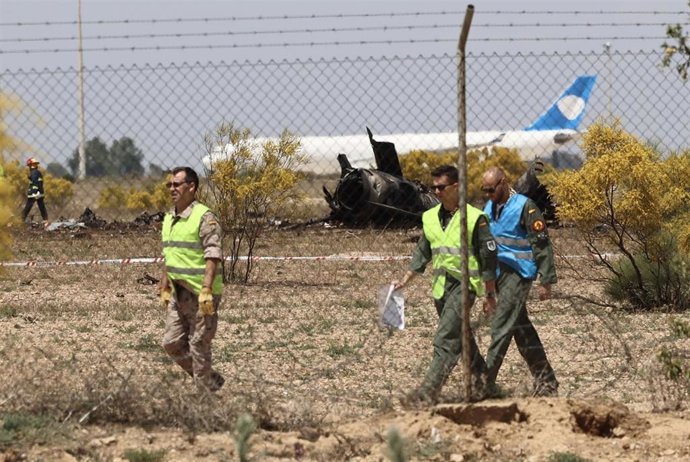 Operarios alrededor de los restos del avión F-18 del Ejército del Aire que se ha estrellado esta mañana en la base aérea de Zaragoza, a 20 de Mayo de 2023, en Zaragoza, Aragón (España). El accidente se ha producido durante una exhibición. 