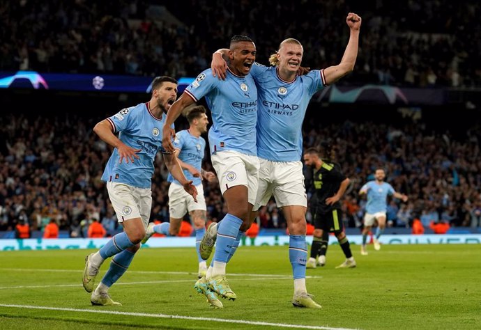 17 May 2023, United Kingdom, Manchester: Manchester City's Rodri, Manuel Akanji, and Erling Haaland celebrate the own goal of Real Madrid's Gabriel Eder Militao during the UEFA Champions League semi-final second leg soccer match between Manchester City 