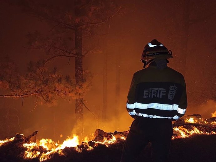 Archivo - Un efectivo de la EIRIF trabaja en las labores de extinción del incendio de Tenerife durante la noche