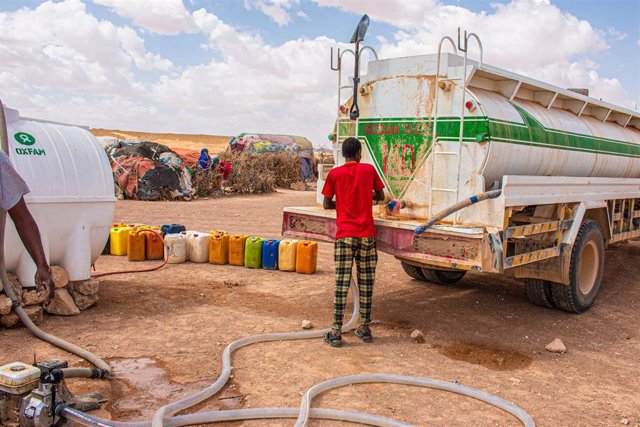 Un camionero entregando agua a las personas desplazadas en el campo de desplazados internos de Galidle, en Somalia.