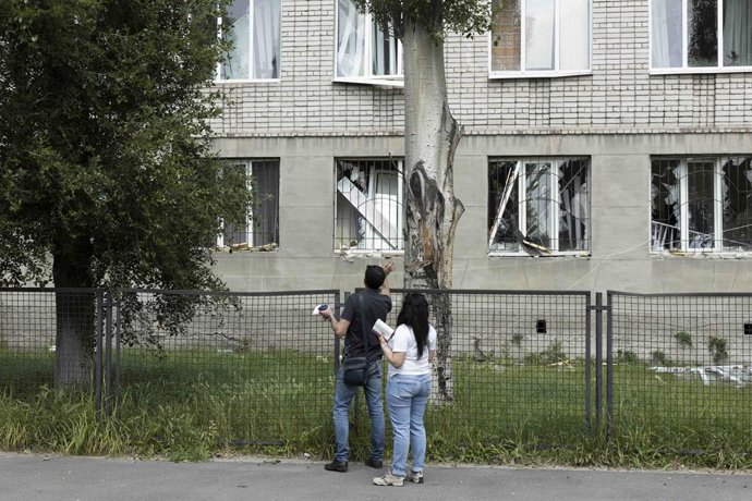 May 26, 2023, Dnipro, Illinois, Ukraine: People look at the damage done to a nearby building after a Russian air strike on a clinic in Dnipro, Ukraine. The Russian air strike hit in the morning and killed at least one person and injured 15 more.