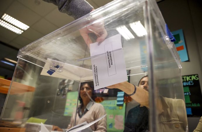 Una persona fica el seu vot en una urna vota en el Centre de Formació Rodrigo Giorgeta