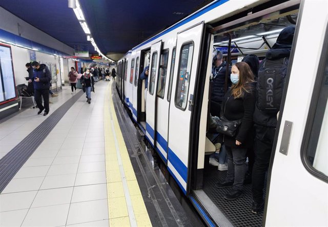 Archivo - Una mujer con mascarilla dentro de un tren de Metro de la estación de Metro de Sol