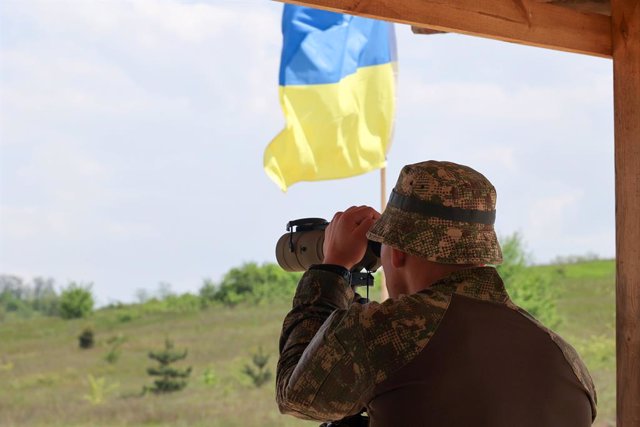 May 18, 2023, Kharkiv Region, Ukraine: A serviceman of the unit of the 3rd Colonel Petro Bolbochan Spartan Brigade of Operational Assignment of the National Guard of Ukraine looks through binoculars during firing and tactical exercises, Kharkiv Region, no
