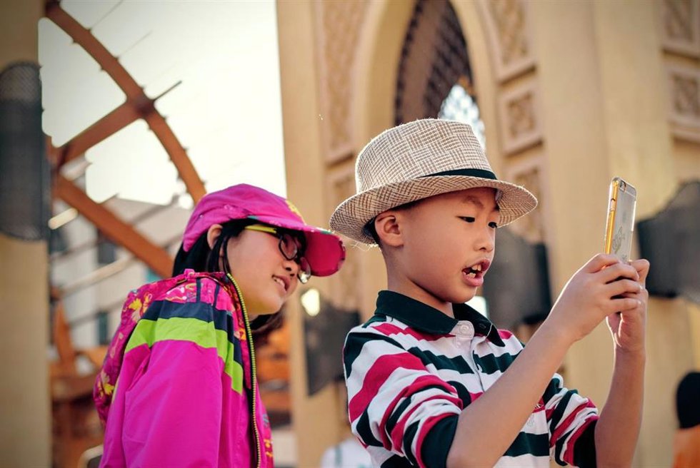 Dos niños mriando un 'smartphone'